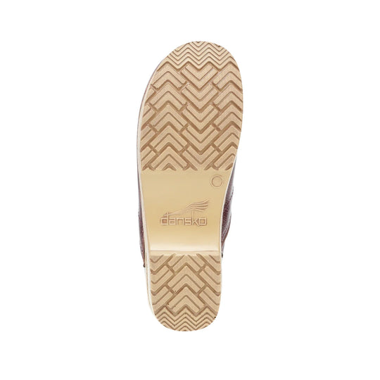 Tan shoe outsole with zigzag tread and embossed Dansko logo
