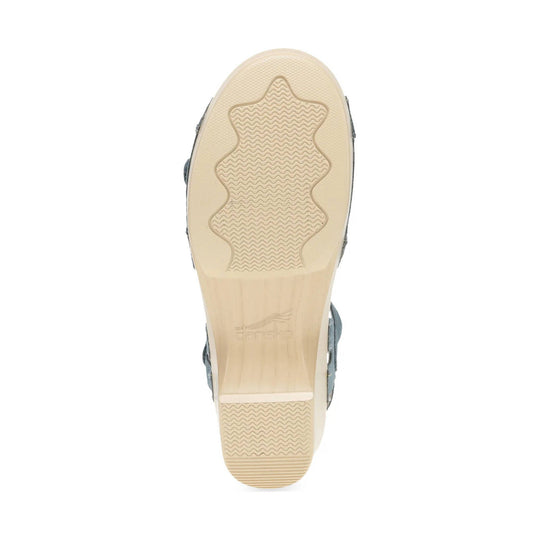 Beige sandal outsole with wavy tread pattern and embossed logo near the arch