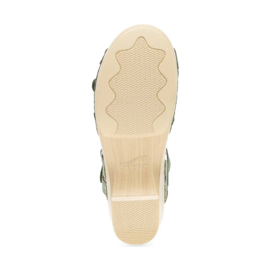 Bottom view of a beige sandal outsole with wavy tread and heel cushioning