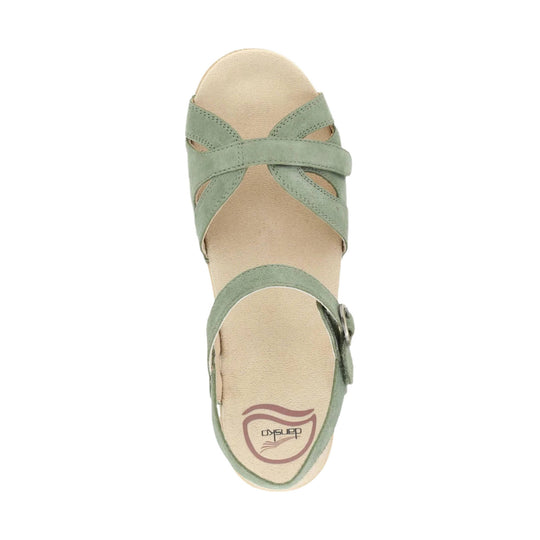 Sage green strappy sandal with a closed toe, side buckle, and Dansko logo on the footbed