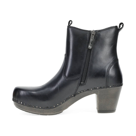 Black leather ankle boot with side zipper, chunky heel, and metal studs around the sole