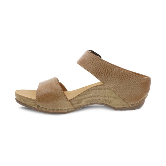 Tan wedge sandal with wide crisscross straps and textured sole, side view