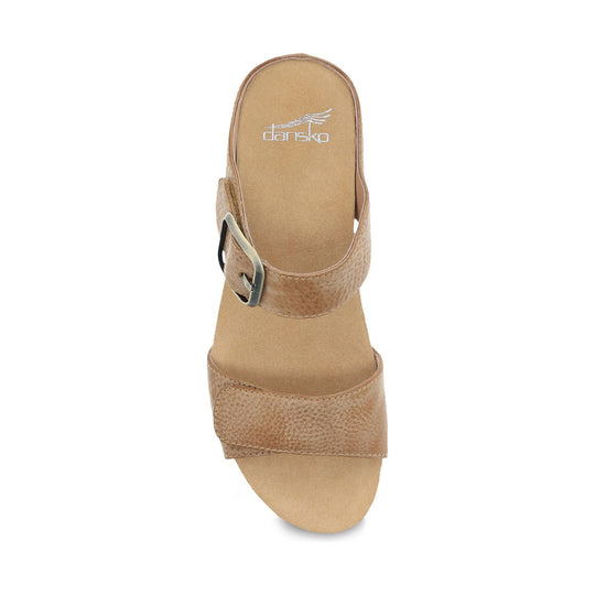 Tan suede slide sandal with an ankle strap, metal buckle, and wide toe band