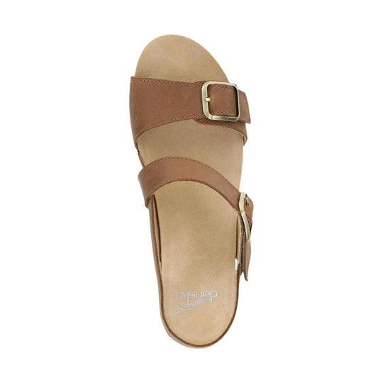 Tan leather sandal with wide straps and metal buckles, top view