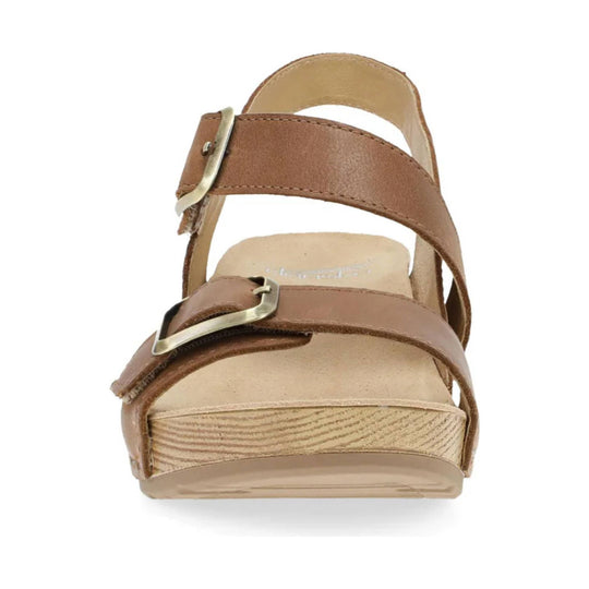 Brown leather sandal with two buckled straps and a cork wedge heel, front view