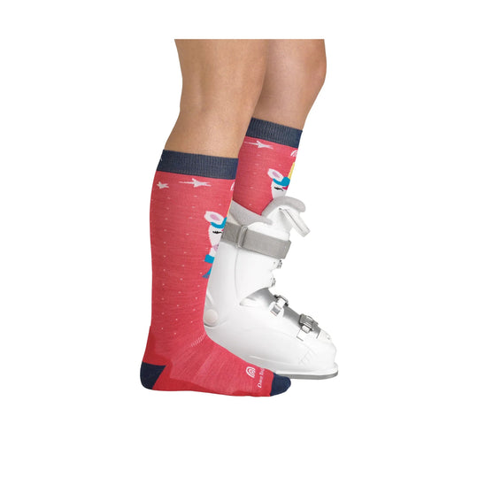 Red over-the-calf ski sock with dark navy cuff, heel, and toe, shown with a white ski boot