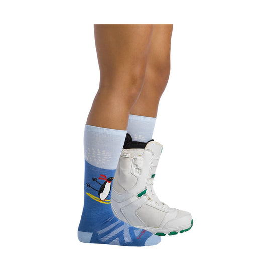Blue knee-high ski sock with a penguin graphic, shown with a white snowboard boot
