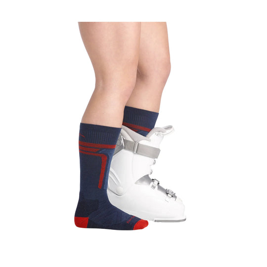 Navy over-the-calf ski sock with red stripes, worn with a white ski boot