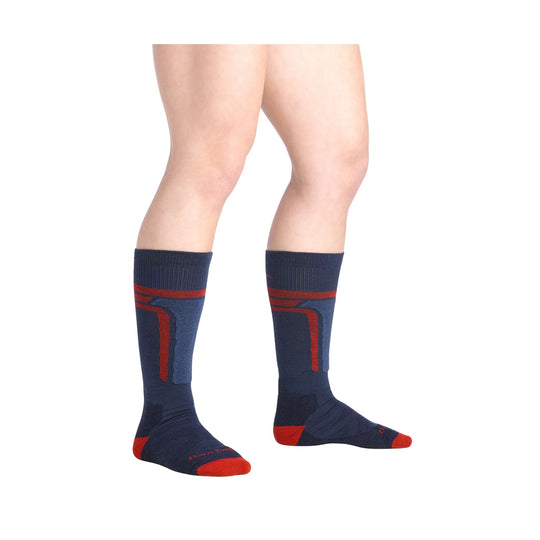 Navy over-the-calf socks with red accents on a model's legs