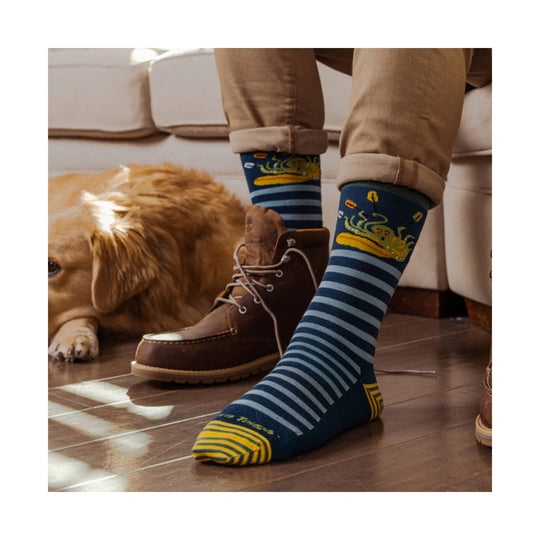 Navy striped crew socks with a yellow octopus pattern, worn with rolled khaki pants and brown boots