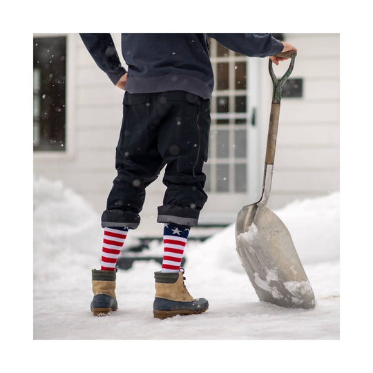 Midweight ski sock with red and white stripes and blue star pattern, shown with tan-and-navy winter boots