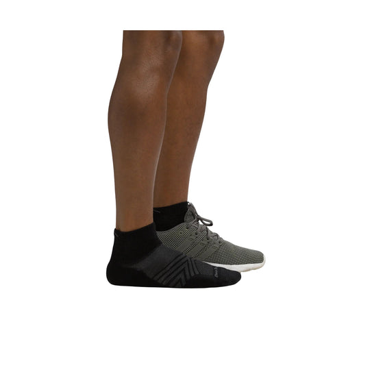 Black ankle running sock with gray geometric stripes and a gray mesh running shoe beside it