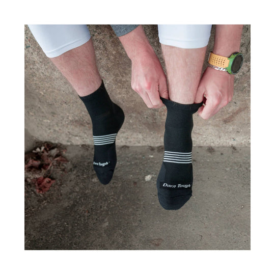 Black ankle running socks with white stripe detail and Darn Tough logo