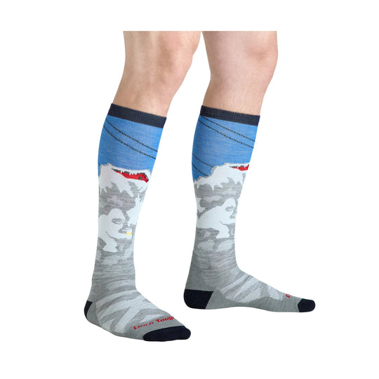 Gray knee-high ski socks with a blue cuff, mountain pattern, and dark toe and heel.