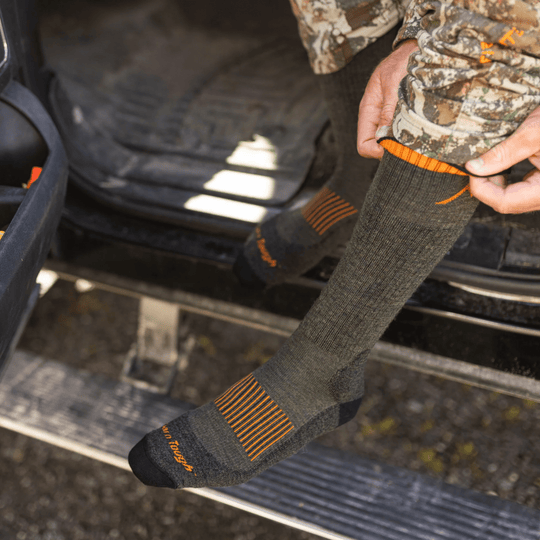 Dark wool hunting boot sock with orange accent stripes and black toe and heel