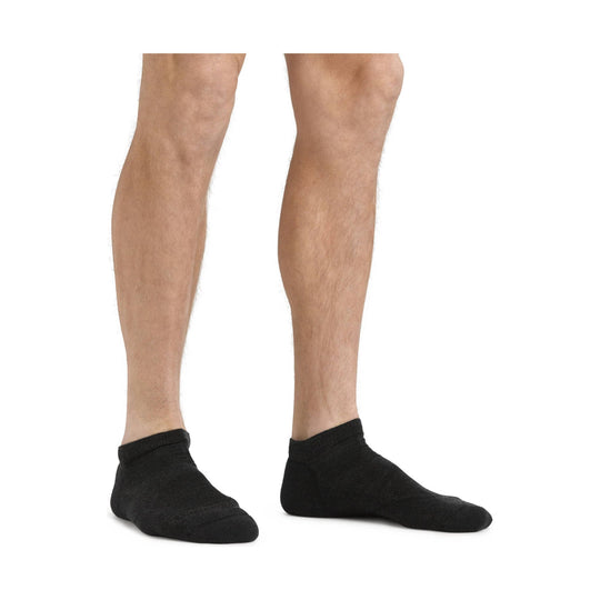 Black no-show socks on a model's feet and lower legs