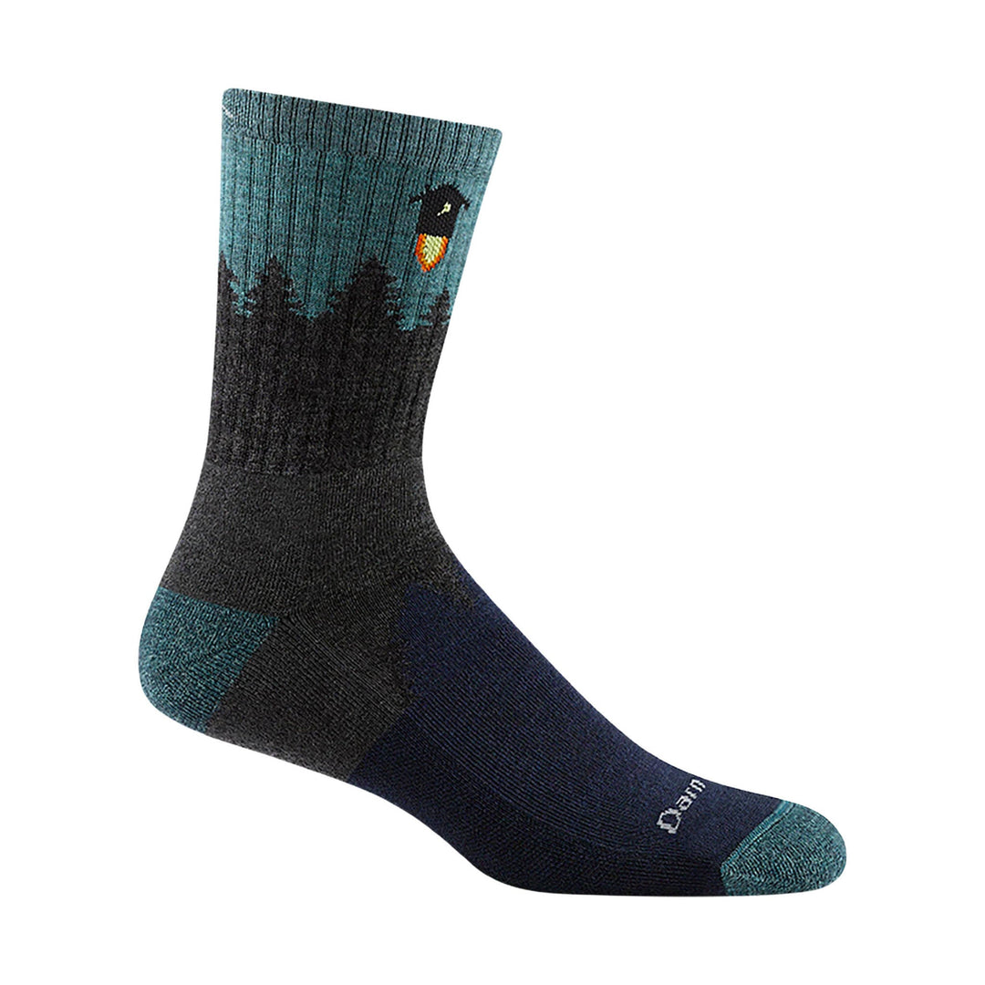 Midweight hiking sock in black and teal with a dark forest pattern and small logo near the cuff