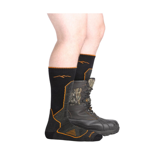 Black over-the-calf hunting socks with orange trim and camo accents, worn with a boot