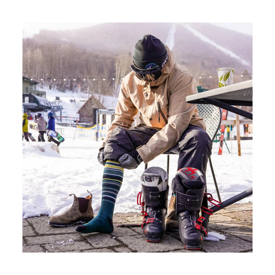Striped over-the-calf ski sock worn with ski boots