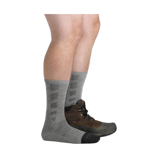 Gray crew work socks with patterned calf panels shown on lower legs with hiking boots