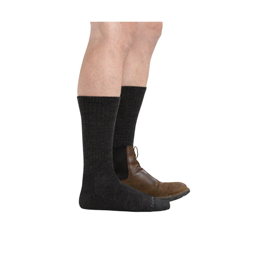 Black knee-high socks worn with brown ankle boots on a model's legs