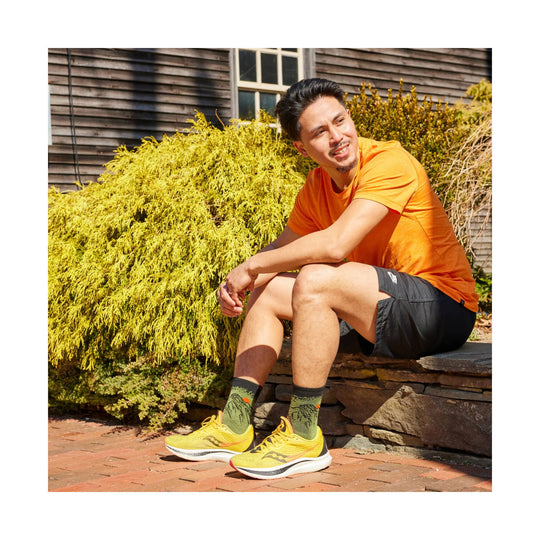 Yellow running shoes with green crew socks