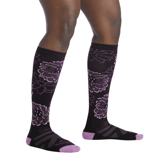 Black over-the-calf socks with purple floral pattern and purple toe and heel accents