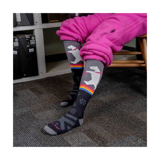 Gray ski socks with white bear graphics and rainbow stripes, worn with bright pink fleece pants
