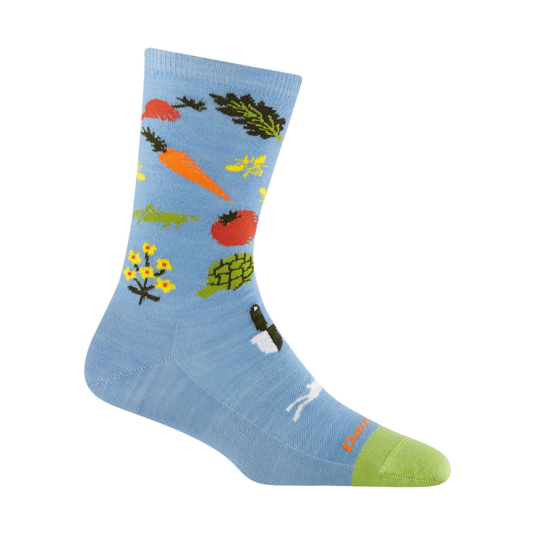 Light blue crew sock with orange, green, yellow, and black market-themed graphics and a green toe