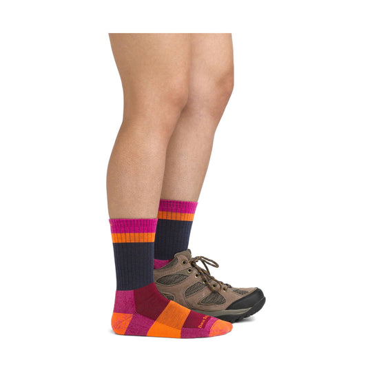 Magenta, orange, and navy striped crew hiking sock with a brown trail shoe