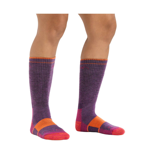 Purple and orange knee-high hiking socks shown on a model's lower legs and feet