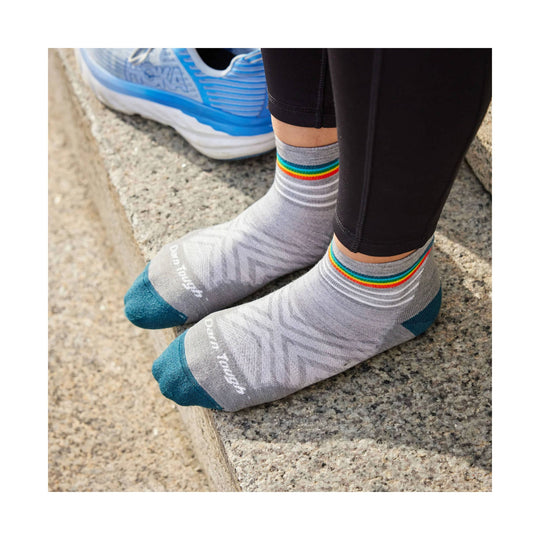 Gray ankle running socks with rainbow stripes at the cuff and teal toes and heels