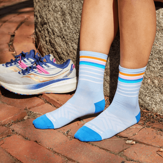 Light blue ankle running socks with white stripes, orange and pink bands, and blue toes and heels