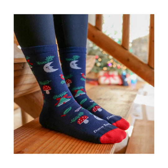 Navy crew socks with holiday patterns, red toes, and visible Darn Tough text