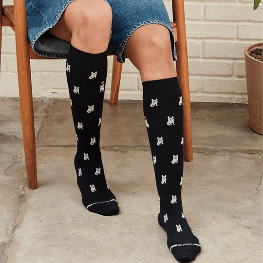 Black knee-high socks with small white dog print and DR. MOTION text at the cuff