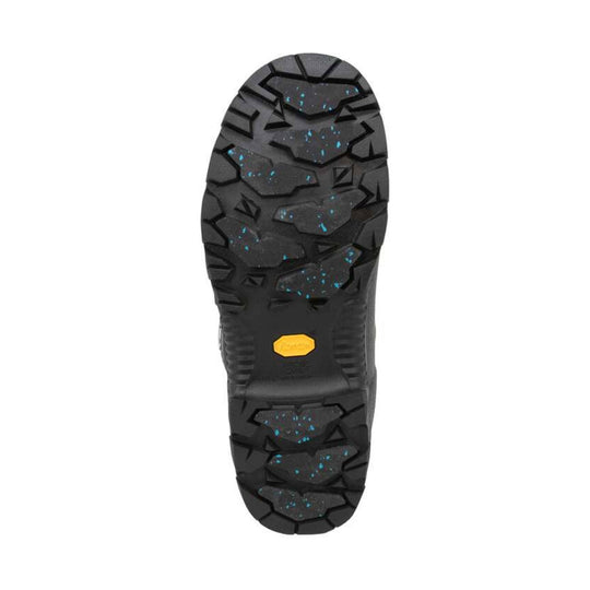 Black boot outsole with rugged tread and a yellow logo insert