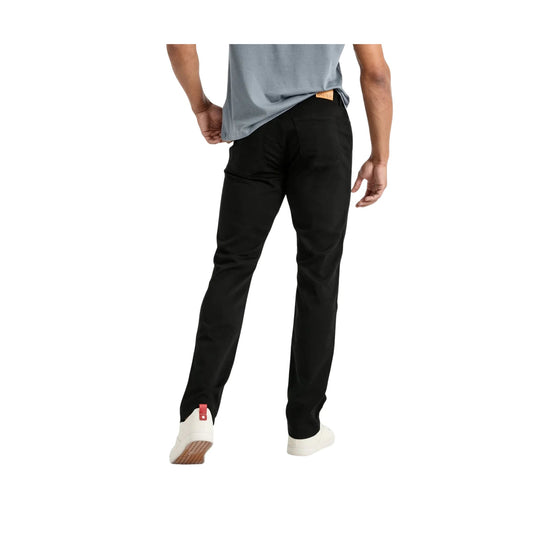Black relaxed-fit tapered pants shown from the back with a small tan waistband label
