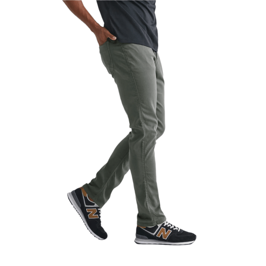 Olive green relaxed-fit pants worn with black New Balance sneakers