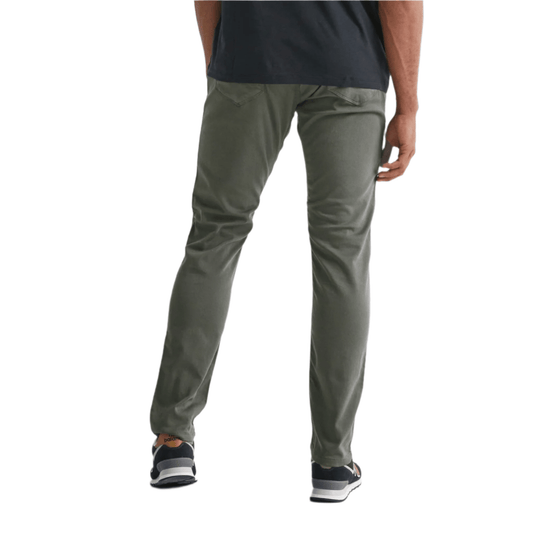 Olive green slim-fit pants shown from the back, worn with a black T-shirt and black sneakers