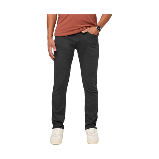 Black relaxed taper pants on a model with hands in pockets
