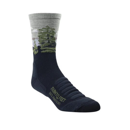 Tall navy sock with a gray cuff, green tree pattern, and small green text near the foot