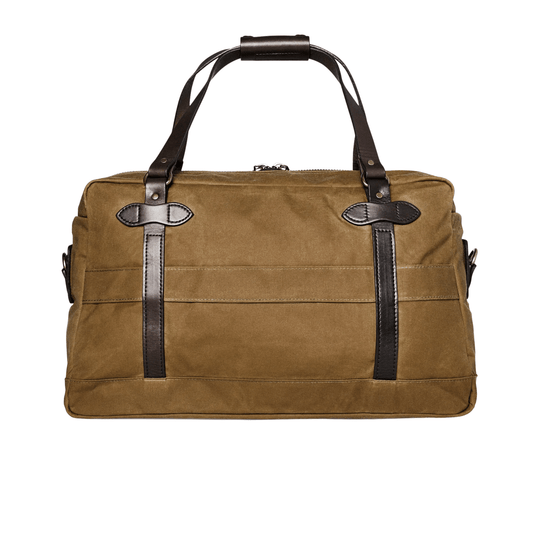 Tan canvas duffel bag with dark leather straps and handles, front view