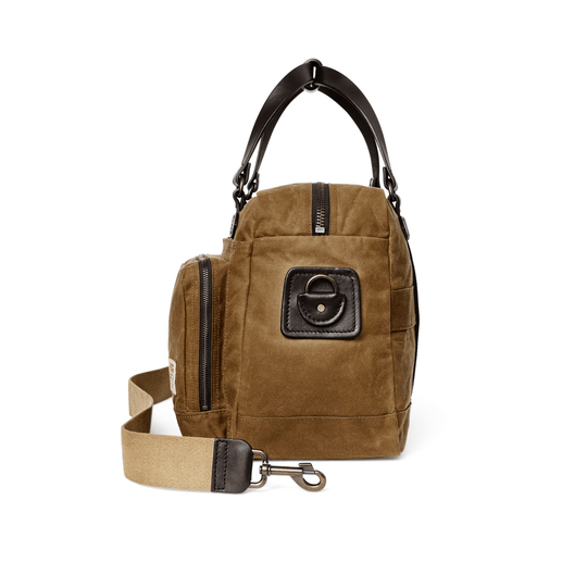 Brown suede duffle bag with black leather top handles, front zip pocket, and detachable shoulder strap
