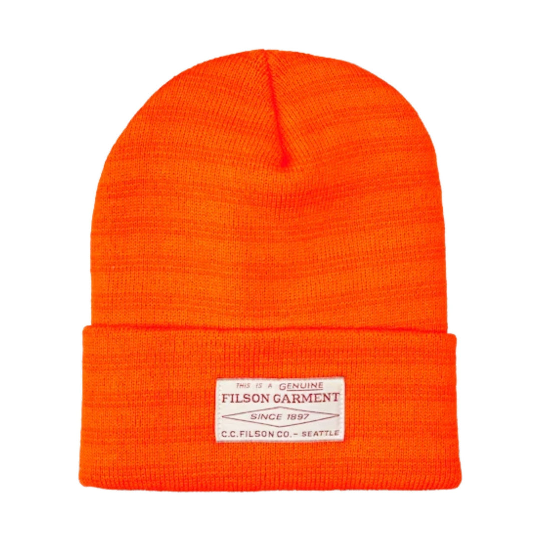 Bright orange knit beanie with a folded cuff and a white front label