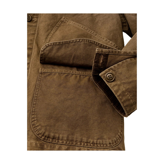 Brown canvas jacket close-up showing flap pockets and buttoned cuff