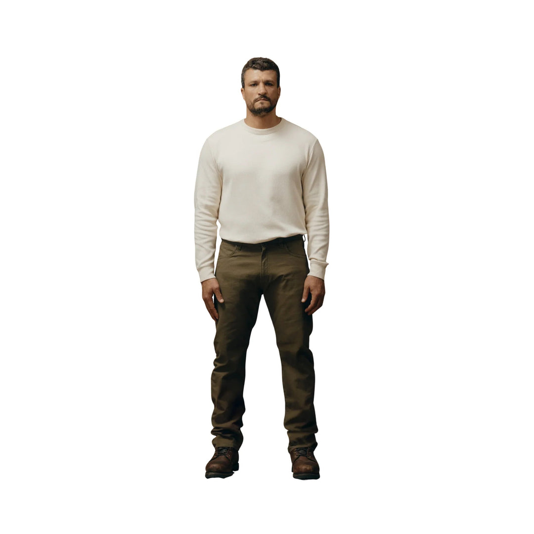 Olive straight-leg pants with a five-pocket design and brown lace-up boots