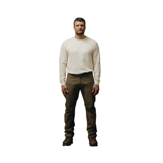 Olive straight-leg pants with a five-pocket design and brown lace-up boots