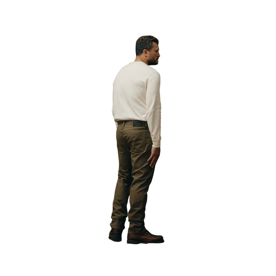 Olive work pants shown from the back with brown boots