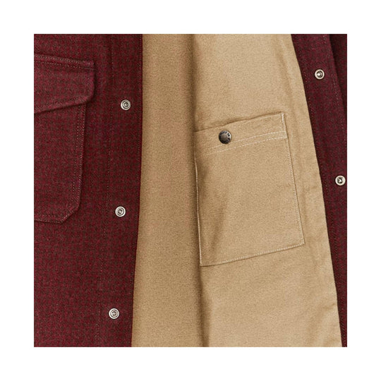 Close-up of a red houndstooth wool shirt with tan lining and chest pockets