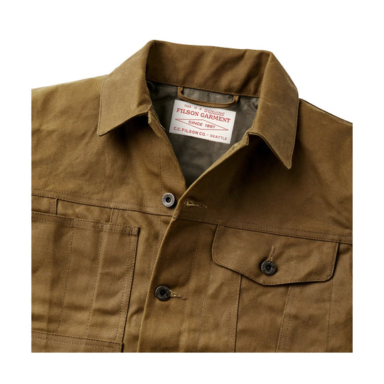 Tan canvas work jacket with chest pockets, buttons, and a Filson garment label inside the collar